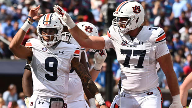 Oct 15, 2022; Oxford, Mississippi, USA; Auburn Tigers quarterback Robby Ashford (9) reacts with offensive lineman Kilian Zierer (77) after a touchdown during the third quarter at Vaught-Hemingway Stadium. Mandatory Credit: Matt Bush-USA TODAY Sports